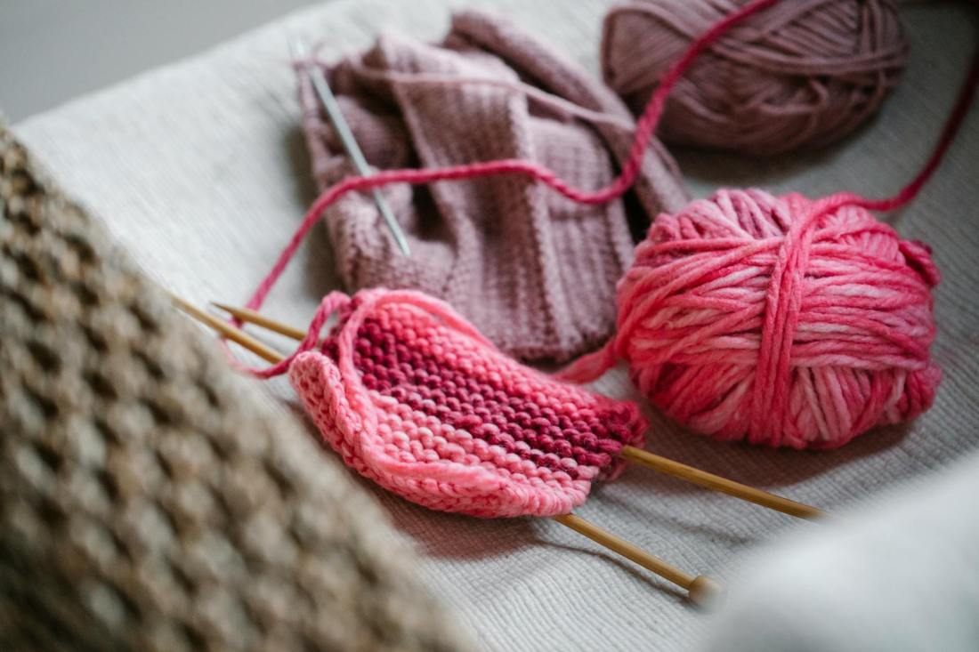colorful pink yarn and needles